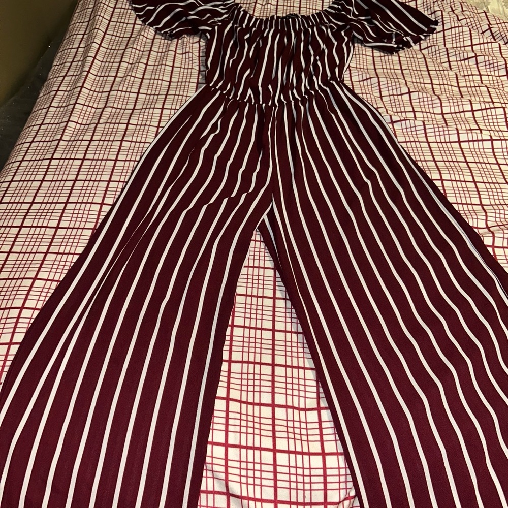 Its a burgundy and white striped dressy jumpsuit and its brand is ambiance